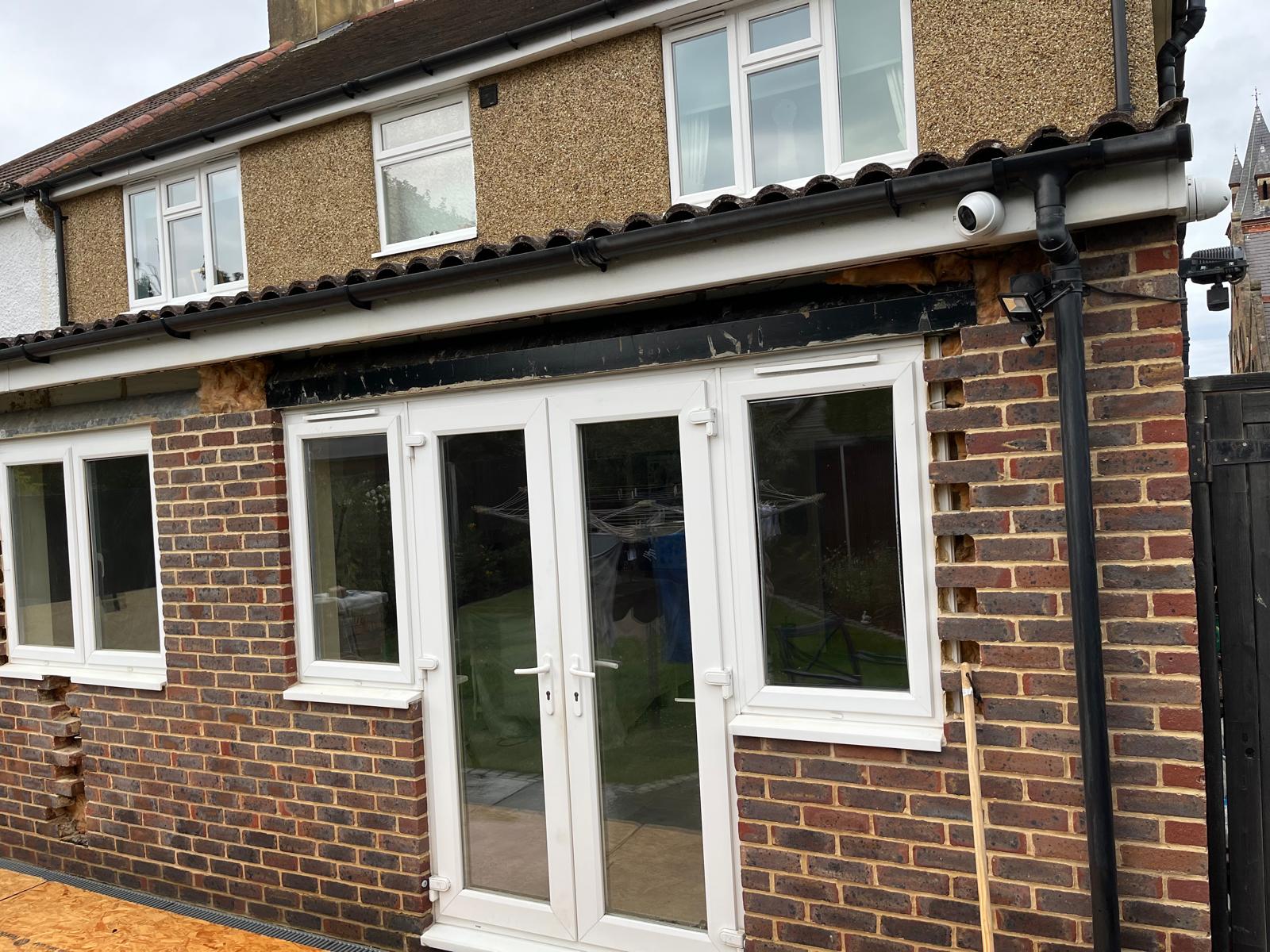 New brick infill and steel lintel above a widened rear opening, part way through construction