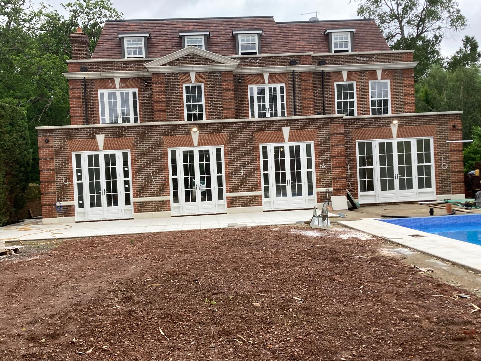 Completed rear brickwork on the new-build house, symmetrical facade with keystone detailing over each opening
